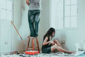 couple painting interior house