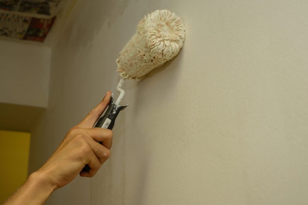 painter painting with paint roller